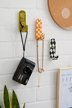 a white brick wall with various objects hanging on it