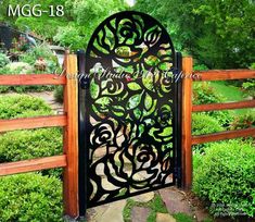 an iron gate in the middle of a garden