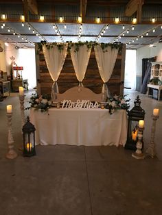 a table is set up for a wedding reception with candles and flowers on the table