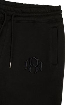 Premium 400gsm Heavyweight Sweatpants crafted with a cozy brushed interior, highlighted with a 3d embroidered monogram. Standard fit, with flat-knit gusset for added flexibility and reverse flatlock stitching. Pre-shrunk and treated to ensure minimal shrinkage. 3D Embroidered Monogram Logo Heavyweight Cotton Reverse Flatlock Stitching Adjustable Drawstrings Waist Single Welt Rear Pocket Model is 5'11" and 202 lb. wearing size Medium. Black Logo Sweatpants For Loungewear, Black Sweatpants With Logo Detail For Loungewear, Black Joggers With Logo For Loungewear, Black Loungewear Joggers With Logo Detail, Black Sporty Pants With Logo Detail, Sporty Black Pants With Logo Detail, Black Athleisure Sweatpants With Logo Detail, Streetwear Cotton Pants With Logo Detail, Streetwear Cotton Bottoms With Embroidered Logo