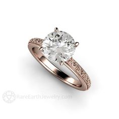 a rose gold engagement ring with an oval cut diamond in the center and filigrees on the sides