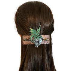 "This fierce dragon skull hair clip will be the perfect addition to your cosplay look.  Give a great gift of a unique hair accessory with handmade dragon art.  This dragon barrette  has been sculpted with polymer clay measuring 4 inches long and 3\" wide (from the top of the wings to the bottom of the skull). The base of the hair clip is made of textured clay hand painted in metallic bronze with filigree scroll detail with green and red crystals.  On the reverse, the 3 inch hair barrette style c