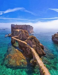 an aerial view of the ocean and castle