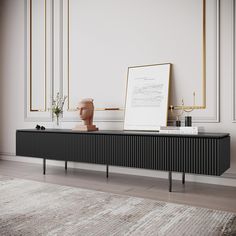 a black and gold sideboard in a white room with an art piece on top