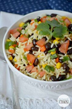 a white bowl filled with rice, black beans and cilantro garnish