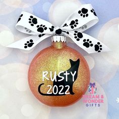 a christmas ornament with a dog's paw print on it