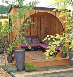 an outdoor living area with couches and potted plants