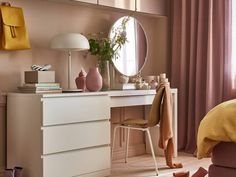 a bedroom with a dresser, mirror and shoes on the floor in front of it