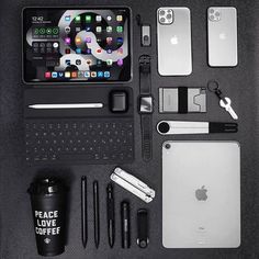 an assortment of electronics and accessories laid out on top of a black surface with the words peace love coffee next to it