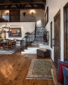 a living room filled with furniture and a staircase leading up to the second floor area