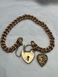 Condition excellent Every link stamped and solid 9ct gold (not hollow) An antique hollow heart charm with full hallmarking  A later yellow gold padlock clasp fully hallmarked fitted with 9ct gold safety chain Small to medium wrist at 17cm Vintage Gold Charm Bracelet With Heart Charm, Vintage Gold Heart Bracelet As Gift, Vintage Gold Heart Bracelet For Gift, Vintage Gold Lock Jewelry, Vintage Gold Jewelry With Lock, Classic Gold Lock Jewelry, Classic Gold Jewelry With Lock Detail, Antique Gold Charm Bracelet, Antique Gold Charm Bracelet Gift