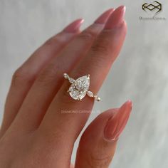 a woman's hand with a diamond ring on it