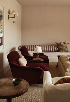 a living room filled with furniture and a painting on the wall