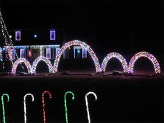 christmas lights are lit up in front of a house