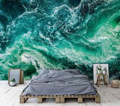 a bedroom with a large wall mural in the shape of an ocean wave and green water