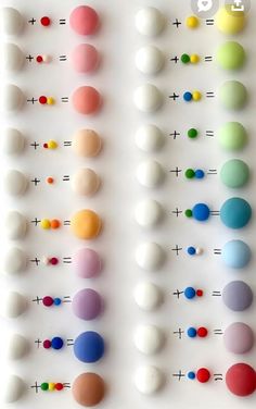 an array of different colored balls arranged on a white surface with numbers and symbols in the middle