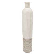 a tall white vase sitting on top of a table