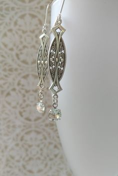 Textured Front, Hollow Back These 1920s inspired earrings feature silver plated Art Deco style brass connectors and sparkling clear Swarovski crystal beads. The dainty brass connectors are very lightweight yet sturdy and slightly hollow on the reverse side. (SEE 2nd PHOTO) They remind me of delicate Edwardian lace. They measure 2 1/2 inches long from the top of the silver plated lever back ear wires to the bottom of the crystal beads An elegant combination for a vintage inspired wedding. ABOUT T Vintage Chandelier Dangle Earrings For Anniversary, Vintage Dangle Chandelier Earrings For Anniversary, Classic Chandelier Earrings With Intricate Design For Anniversary, Vintage Chandelier Earrings For Anniversary, Classic Chandelier Earrings For Anniversary, Victorian Silver Bridal Earrings For Formal Events, Victorian Silver Bridal Earrings For Formal Occasions, Vintage Formal Filigree Chandelier Earrings, Antique Silver Metal Earrings For Wedding