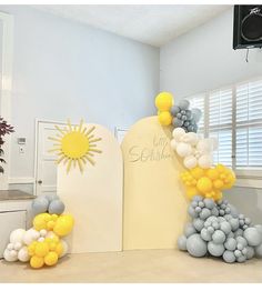 balloons and decorations are on display in an office setting, with the sun above them