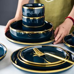 a table topped with blue and gold dishes