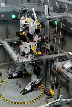 a model of a sci - fi space station with people standing around it and looking at the action