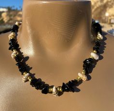 This piece is made with: 🐚black onyx beads 🐚seashell beads 🐚gold seed beads 🐚lobster claw clasp 🐚17.5 inches 🐚2 inch extender Onyx gives strength.  Imparts self-confidence, helping you to be at ease in your surroundings.  Onyx banishes grief, enhances self-control and stimulates the power of wise decision-making.  It encourages happiness and good fortune. Black Shell Jewelry As A Gift, Black Shell Jewelry For Gifts, Black Shell Jewelry Gift, Elegant Black Necklace For The Beach, Elegant Black Necklace For Beach, Black Round Beads Jewelry For Beach, Black Beaded Jewelry For The Beach, Handmade Black Shell Necklaces, Handmade Black Shell-shaped Jewelry