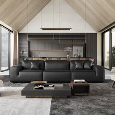 a modern living room with black leather couches and white carpeted area rugs