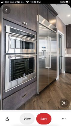 a stainless steel refrigerator and oven in a kitchen with wood floors, cabinets and drawers