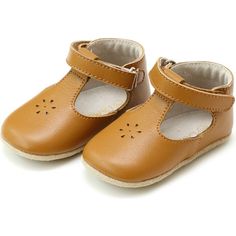 a pair of brown baby shoes on a white background