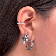 Sparkle on with this unique, Zircon ear cuff. Crafted with zircon for a glamorous shine, it adds a hint of sparkle to any outfit without the need for piercing your ear. Silver Cubic Zirconia Ear Cuff For Party, Trendy Cubic Zirconia Single Cartilage Earring, Trendy Silver Ear Cuff With Matching Earrings, Silver Cubic Zirconia Ear Cuff As Gift, Cubic Zirconia Single Ear Cuff For Party, Single Cubic Zirconia Cartilage Earring For Party, Single Cubic Zirconia Ear Cuff For Party, Trendy Silver Cubic Zirconia Earrings, Gold Ear Cuff