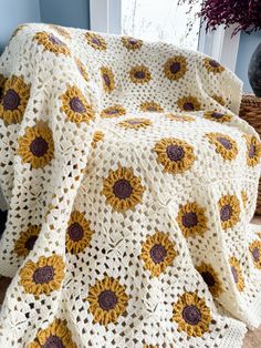 a crocheted sunflower blanket sitting on top of a chair