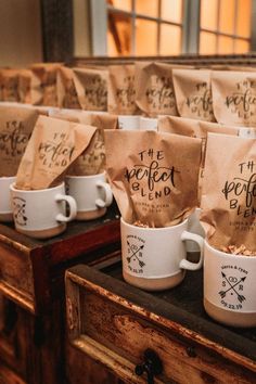 several coffee bags with the words, the perfect blend are lined up in white mugs