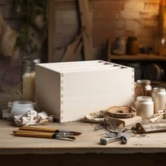 a wooden box sitting on top of a table next to other tools and items in front of it