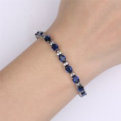 Blue sapphire bracelet (handmade) presents diamond accents. The oval-cut gemstones are set in a 14K white gold-filled tennis-style bracelet setting. The lab-created gemstones (September birthstones) closely replicate the properties of their earth-mined counterparts. Free gift box included with purchase of this link bracelet. Main Gemstone: Blue Sapphire Main Gemstone Size: 7 x 5 mm Main Gemstone Weight: 1.2 Carat (Per Stone) Main Gemstone Origin: Lab-Created Accent Gemstone: Diamond Accent Gemst Sapphire Jewelry Set, Sapphire Tennis Bracelet, Blue Sapphire Bracelet, Vintage Sapphire, Crystal Bangle, Sapphire Bracelet, Solid Gold Jewelry, Tennis Bracelet Diamond, Sapphire Jewelry