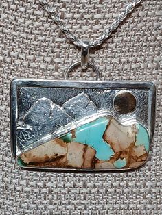 Royston Ribbon turquoise and sterling silver pendant with mountain scene. Measures about 51mm X 47mm. CHAIN NOT INCLUDED. Metalsmithing Jewelry, Mountain Scene, Jewelry Tutorials, Turquoise Sterling Silver, Sterling Silver Pendant, Handcrafted Jewelry, Sterling Silver Pendants, Pendant Necklaces, Jewelry Art