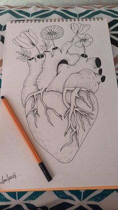 a drawing of a heart with flowers on it and a pencil in front of it