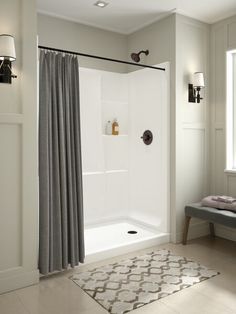 a bathroom with a shower and rug on the floor