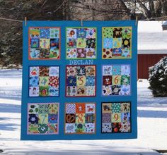 a quilt hanging on a clothes line in the snow