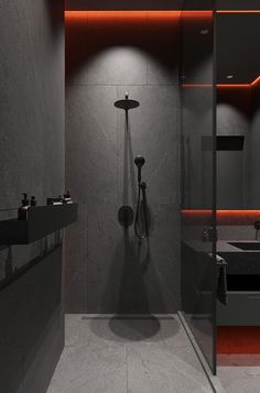 a modern bathroom with grey walls and red lighting in the shower area, along with two sinks