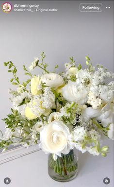 a vase filled with white flowers on top of a table