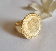 Gold coin ring, coin pinky ring, gold signet ring, coin signet ring, cocktail ring vintage style coin ring, vintage gold ring, pinky ring This gold coin ring is made of a British 5p coin which was decorated with braided gold filled wires and attached to a wide handmade band, creating a lovely signet ring. The coin coin ring is designed in a vintage style and is available both in 14k gold plating over brass or silver as well as sterling silver (see last photo). The ring is a great cocktail ring a Vintage Coin Signet Ring As Gift, Vintage Coin Shaped Signet Ring Gift, Vintage Coin Signet Ring For Gift, Elegant Engraved Coin Rings, Vintage Engraved Coin Signet Ring, Gold Coin-shaped Engraved Ring, Hallmarked Coin Shaped Signet Ring As Gift, Gold Coin-shaped Signet Ring For Gift, Gold Coin Shaped Signet Ring