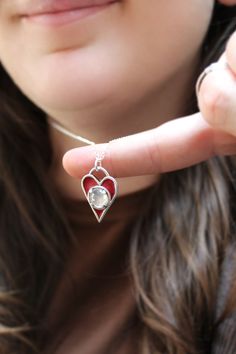 This finely crafted sterling silver heart necklace has three layers of red enamel that is kiln fired to the surface at 1400 degrees. This makes for a durable waterproof and vibrant pendant. I finish it off with a prong set 8mm pink white topaz gemstone. This also has a layered heart detail along with my makers mark on the reverse side. The pendant comes on an adjustable sterling silver chain that can be clasped anywhere between 16 and 20 inches. I ship USPS First Class with tracking, in a gift b Unique Red Heart Shaped Jewelry, Red Sterling Silver Heart Pendant Jewelry, Valentine's Day Heart Pendant Necklaces, Silver Enamel Heart Pendant Necklace, Silver Heart-shaped Enamel Jewelry, Heart-shaped Silver Enamel Jewelry, Silver Enamel Necklace For Anniversary, Heart Cut Enamel Jewelry For Gifts, Red Sterling Silver Heart Pendant Necklace