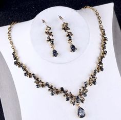 Perfect for a gothic wedding, this beautiful three-piece bridal jewelry set is adorned with intricately faceted smokey black rhinestones that capture the light from every angle with a perfectly translucent appeal. All pieces are antique gold plated for a flawless finish which enhances the intricate detailing and conveys a modern take on old elegance. Necklace: 16.5" (approx. 42cm) long with a 3" (approx. 8cm) extension chain for comfortable sizing. If you would like it longer, please include a m Black Wedding Jewelry, Pearl Bridal Jewelry Sets, Crown Necklace, Pearl Bridal Jewelry, Bridal Hair Jewelry, Crystal Tiaras, Pearl Bridal, Wedding Accessories Jewelry, Hair Jewelry Wedding