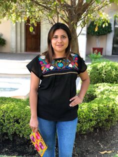 "We know there is no fiesta without the right outfit. This beautiful mexican blouse is handmade embroidered. So colorful and vibrant flowers. Will be perfect for your summer fiestas, or any boho-hippie style. Made of cotton Size: one size fits all Measurements: 17\" x 26\" This listing is for one BLACK mexican embroidered blouse All orders are shipped using Mexican Postal Service and it takes: 15-25 bussines days (North America). 20-30 bussines days (Europe). 20-35 bussines days (Rest of the wor Multicolor Embroidered Tops For Cinco De Mayo Fiesta, Summer Fiesta Tops With Embroidered Neckline, Cinco De Mayo Fiesta Blouse With Multicolor Embroidery, Summer Fiesta Top With Geometric Embroidery, Short Sleeve Embroidered Top For Fiesta With Embroidered Neckline, Multicolor Embroidered Top For Fiesta, Short Sleeve Embroidered Top For Fiesta, Embroidered Fiesta Blouse, Summer Cotton Embroidered Top For Fiesta