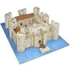 a paper model of a castle on a blue mat