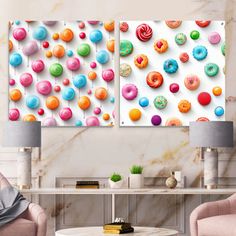 two canvases with colorful donuts on them in a living room next to a coffee table