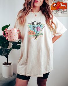 Made from 100% cotton, this Oversized Summer Retro Shirt is designed to keep you cool and comfortable all day long. The retro-inspired graphic is professionally printed, ensuring that the colors and details are captured perfectly. Our Women's Graphic Tee is a relaxed fit and designed to be a perfect Aesthetic Shirt that will add a touch of nostalgia to your summer clothes collection. Don't miss out on this summer must-have! T-Shirt DETAILS -Designs are professionally printed. -Comfortable relaxed fit  -100% Cotton, except heather colors (Cotton Poly blend) -Shirts are a unisex fit, please check the size chart in the images for details. Current processing time:  3-5 Days Shipping Time:  3-5 Days CUSTOM REQUESTS: Currently not accepting unless bulk order(10+ items).  Returns / Defects:  If y Long Sleeve Cotton Tops In Vsco Style, White Graphic Print Shirt For Loungewear, Cotton Long Sleeve Vsco Tops, Relaxed Fit Graphic Print Shirt For Loungewear, Graphic Print Shirt Relaxed Fit For Loungewear, Cotton Vsco Style Tops With Screen Print, Cotton Vsco Tops With Screen Print, Vsco Cotton Tops With Screen Print, Retro Relaxed Fit Shirt For Everyday