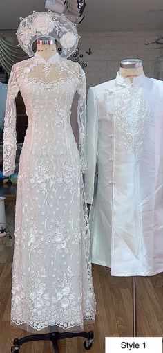 two mannequins dressed in white dresses and hats