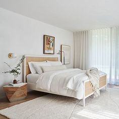 a bedroom with a large bed and white walls