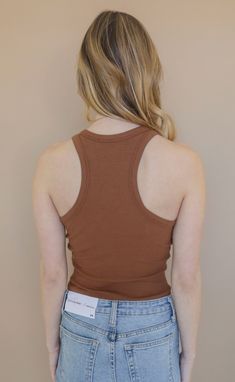 Working on a capsule closet? Be sure to add this basic! This fitted, racerback tank comes in a chocolate brown that can be worn alone or layered season after season. Lili is 5'6" and is wearing size extra small extra small measurements: 29" bust | 18" length 95% rayon | 4% elastane PRODUCTS ON SALE ARE FINAL SALE! Feel free to email us at orders@shopriffraff.com or DM us with any questions regarding fit, styling, or our return policy in general. Trendy Fitted Brown Tank Top, Fitted Brown Basic Crop Top, Brown Fitted Crop Top For Everyday, Fitted Brown Crop Top For Everyday, Brown Stretch Tank Top, Brown Fitted Tank Top, Brown Fitted Casual Tank Top, Fitted Brown Scoop Neck Top, Everyday Brown Crop Top